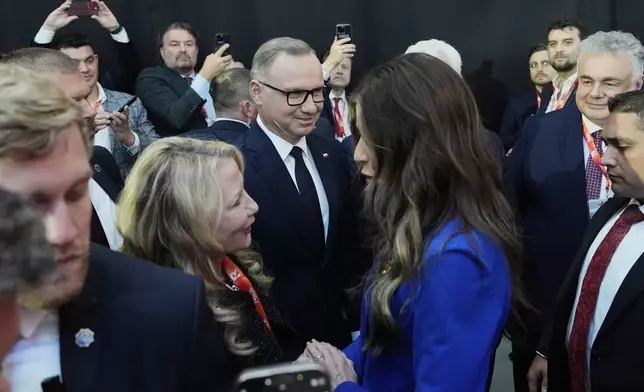 Homeland Security Secretary Kristi Noem, center right, and Poland's President Andrzej Duda, center left, speak with attendees at the Conservative Political Action Conference, CPAC, Tuesday, May 27, 2025, in Jasionka, Poland. (AP Photo/Alex Brandon, Pool)