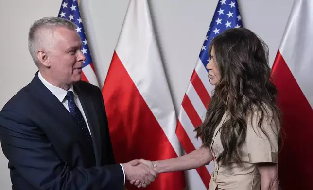 Homeland Security Secretary Kristi Noem, right, shakes hands with Poland's Interior Minister Tomasz Siemoniak, Tuesday, May 27, 2025, in Rzeszów, Poland (AP Photo/Alex Brandon, Pool)
