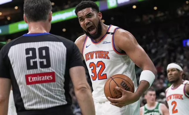 New York Knicks center Karl-Anthony Towns (32) argues a call with referee Mark Lindsay (29) during the first half of Game 2 of an NBA basketball second-round playoff series against the Boston Celtics, Wednesday, May 7, 2025, in Boston. (AP Photo/Charles Krupa)