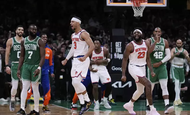 New York Knicks guard Josh Hart (3) and center Mitchell Robinson (23) celebrate after defeating the Boston Celtics in Game 2 of an NBA basketball second-round playoff series, Wednesday, May 7, 2025, in Boston. (AP Photo/Charles Krupa)