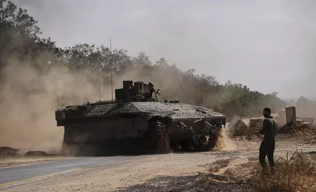 Israeli forces move along the border with the Gaza Strip, in southern Israel, Monday, May 19, 2025. (AP Photo/Ohad Zwigenberg)