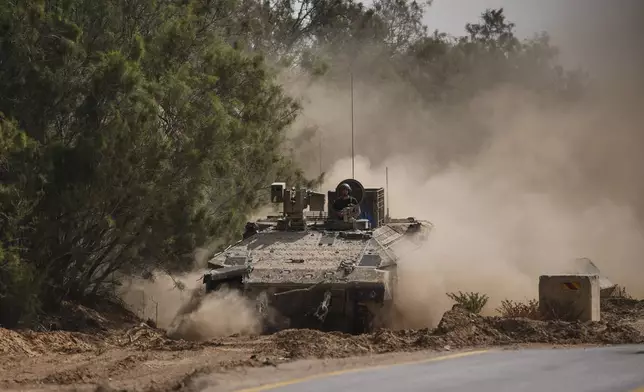 Israeli forces move along the border with the Gaza Strip, in southern Israel, Monday, May 19, 2025. (AP Photo/Ohad Zwigenberg)