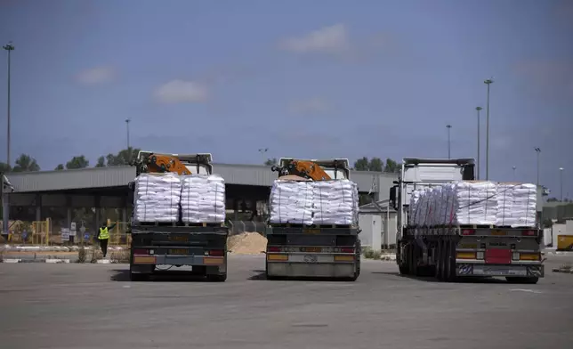Trucks carrying humanitarian aid for the Gaza Strip are seen at the Kerem Shalom Crossing in southern Israel, Monday, May 19, 2025. A day after Israel said it would resume allowing aid into the territory. (AP Photo/Ohad Zwigenberg)