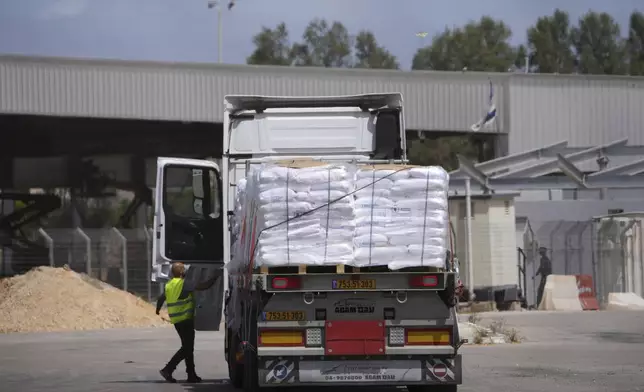 Trucks carrying humanitarian aid for the Gaza Strip are seen at the Kerem Shalom Crossing in southern Israel, Monday, May 19, 2025. A day after Israel said it would resume allowing aid into the territory. (AP Photo/Ohad Zwigenberg)