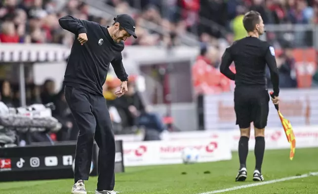 Freiburg coach Julian Schuster reacts, during the German Bundesliga soccer match between, SC Freiburg and Bayer Leverkusen, at Europa-Park Stadium, in Freiburg im Breisgau, Germany, Sunday, May 4, 2025. (Harry Langer/dpa via AP)