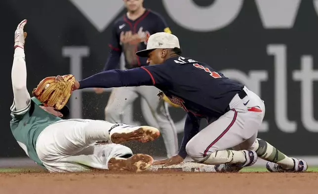 Atlanta Braves second baseman Ozzie Albies, right, tags out Boston Red Sox's Nick Sogard, left, during the seventh inning of a baseball game Friday, May 16, 2025, in Boston. (AP Photo/Mark Stockwell)