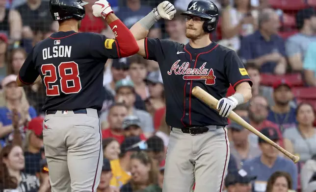 Atlanta Braves' Matt Olson (28) celebrates after his home run with teammate Sean Murphy, right, during the second inning of a baseball game against the Boston Red Sox, Friday, May 16, 2025, in Boston. (AP Photo/Mark Stockwell)