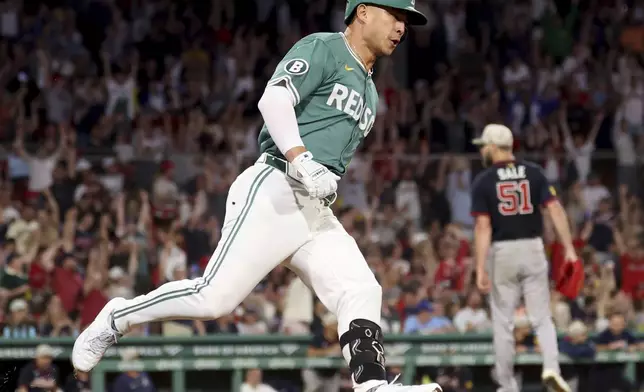 Boston Red Sox's Rob Refsnyder rounds first base after hitting a home run during the seventh inning of a baseball game against the Atlanta Braves, Friday, May 16, 2025, in Boston. (AP Photo/Mark Stockwell)