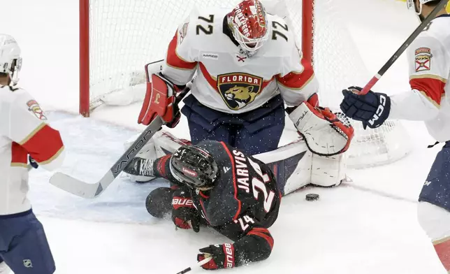 Carolina Hurricanes center Seth Jarvis (24) crashes into Florida Panthers goaltender Sergei Bobrovsky (72) during the second period of Game 5 of the NHL hockey Stanley Cup Eastern Conference finals Wednesday, May 28, 2025, in Raleigh, N.C. (AP Photo/Chris Seward)