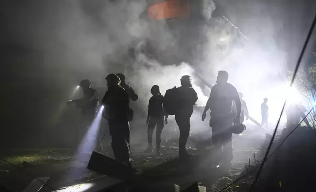Emergency personnel work at the site of a residential building destroyed by a Russian strike in Zaporizhzhia, Ukraine, on Thursday, May 1, 2025. (AP Photo/Kateryna Klochko)
