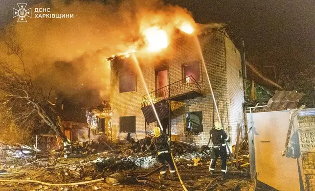 In this photo provided by the Ukrainian Emergency Service, emergency services personnel work to extinguish a fire following a Russian attack in Kharkiv, Ukraine, Wednesday, April 30, 2025. (Ukrainian Emergency Service via AP)