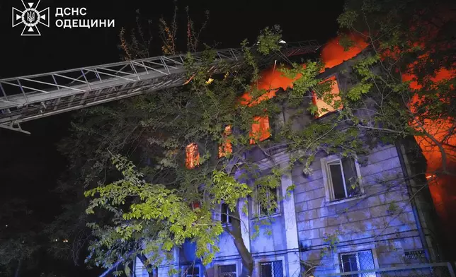In this photo provided by the Ukrainian Emergency Service, firefighters put out the fire at an apartment house following Russia's air raid in Odesa, Ukraine, Thursday, May 1, 2025. (Ukrainian Emergency Service via AP)