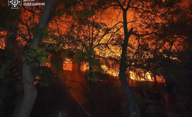 In this photo provided by the Ukrainian Emergency Service, firefighters put out the fire at an apartment house following Russia's air raid in Odesa, Ukraine, Thursday, May 1, 2025. (Ukrainian Emergency Service via AP)