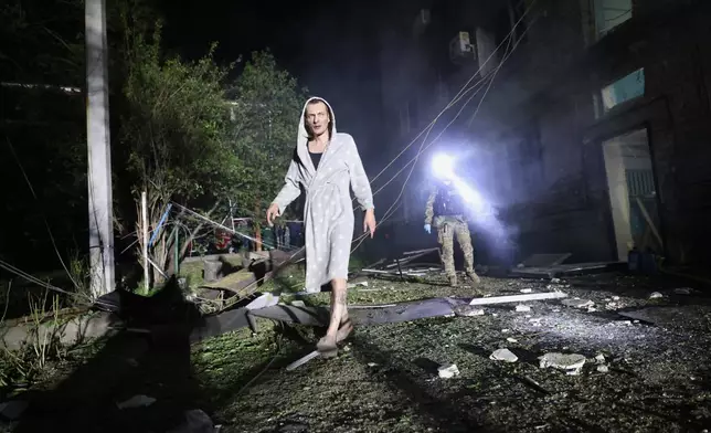 A man walks in a yard of a residential building destroyed by a Russian strike in Zaporizhzhia, Ukraine, Thursday, May 1, 2025. (AP Photo/Kateryna Klochko)