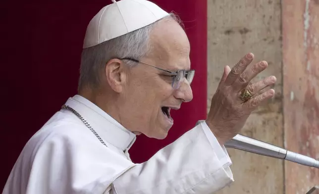 Pope Leo XIV speaks from the central balcony of St. Peter's Basilica from where he delivered his first Sunday blessing since his election to the faithful gathered in St. Peter's Square for the traditional Regina Caeli prayer at noon, on Sunday, May 11, 2025. (AP Photo/Domenico Stinellis)