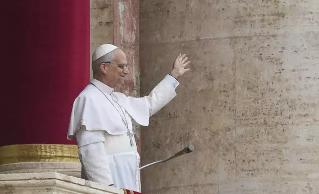 Pope Leo XIV appears at the central balcony of St. Peter's Basilica for his first Sunday blessing after his election, in St. Peter's Square at the Vatican, Sunday May 11, 2025. (AP Photo/Domenico Stinellis)