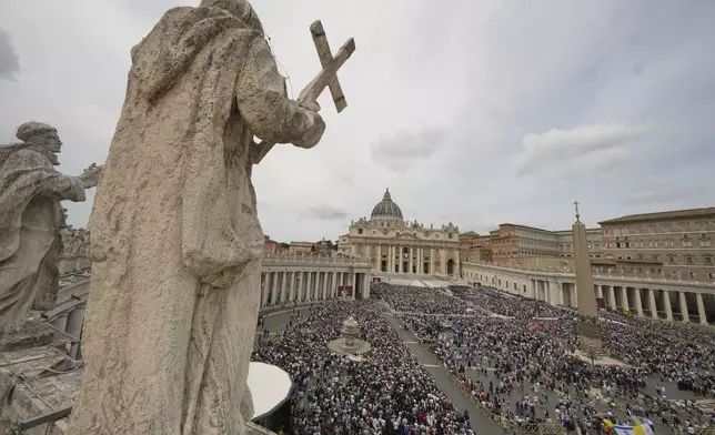 Pope Leo XIV appears at the central balcony of St. Peter's Basilica for his first Sunday blessing after his election, in St. Peter's Square at the Vatican, Sunday May 11, 2025. (AP Photo/Alessandra Tarantino)