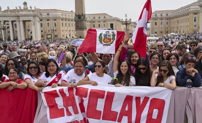 Faithful from Chiclayo, Peru, wave flags and react as Pope Leo XIV appears at the central balcony of St. Peter's Basilica for his first Sunday blessing after his election, in St. Peter's Square at the Vatican, Sunday, May 11, 2025.(AP Photo/Bernat Armangue)