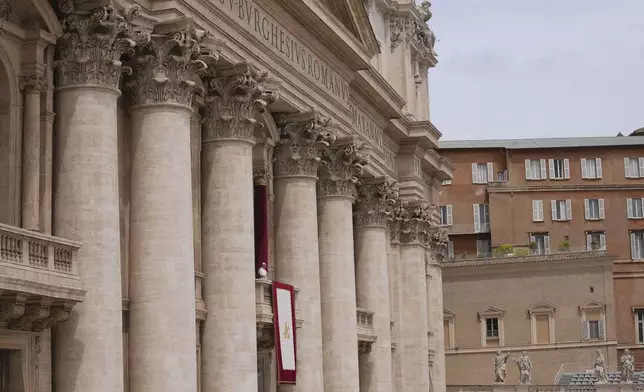 Pope Leo XIV appears at the central balcony of St. Peter's Basilica for his first Sunday blessing after his election, in St. Peter's Square at the Vatican, Sunday May 11, 2025. (AP Photo/Domenico Stinellis)