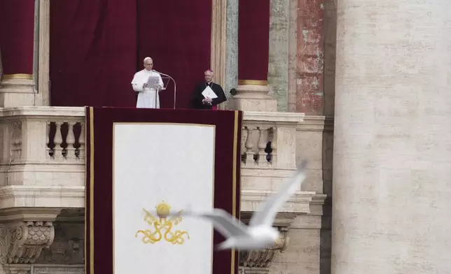 Pope Leo XIV appears at the central balcony of St. Peter's Basilica for his first Sunday blessing after his election, in St. Peter¥s Square at the Vatican, Sunday May 11, 2025. (AP Photo/Alessandra Tarantino)