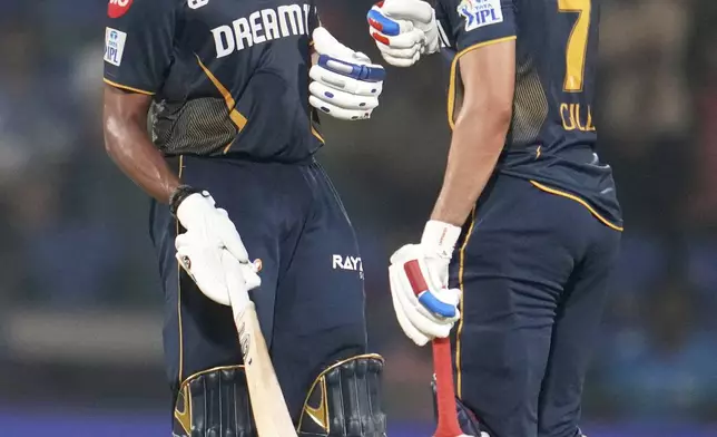 Gujarat Titans' Sai Sudharsan, left, is congratulated by captain Shubman Gill after scoring a century during the Indian Premier League cricket match between Delhi Capitals and Gujarat Titans at Arun Jaitley Stadium in New Delhi, India, Monday, May 19, 2025. (AP Photo/Manish Swarup)