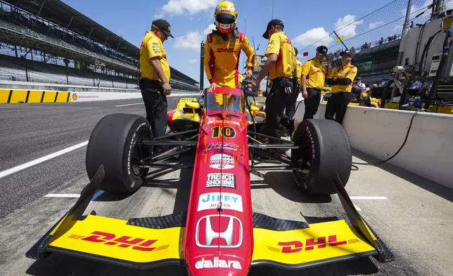 Alex Palou, of Spain, climbs into his car during practice for the Indianapolis 500 auto race at Indianapolis Motor Speedway in Indianapolis, Friday, May 16, 2025. (AP Photo/Michael Conroy)