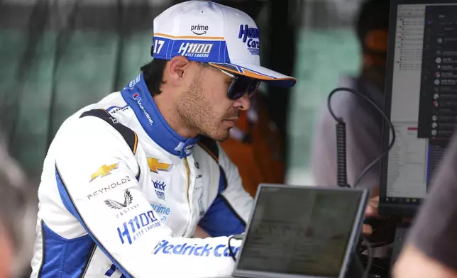 Kyle Larson looks over data after driving during practice for the Indianapolis 500 auto race at Indianapolis Motor Speedway in Indianapolis, Wednesday, May 14, 2025. (AP Photo/Michael Conroy)