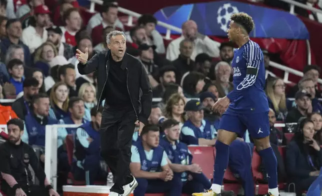 PSG's head coach Luis Enrique gestures to PSG's Desire Doue during the Champions League semifinal first leg soccer match between Arsenal and Paris Saint-Germain at Arsenal Stadium in London, England, Tuesday, April 29, 2025. (AP Photo/Kin Cheung)