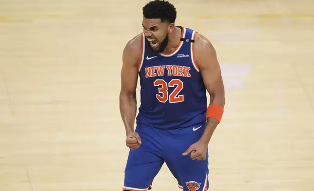 New York Knicks center Karl-Anthony Towns (32) reacts after scoring against the Indiana Pacers during the second half of Game 3 of the Eastern Conference finals of the NBA basketball playoffs Sunday, May 25, 2025, in Indianapolis. (AP Photo/Jeff Roberson)