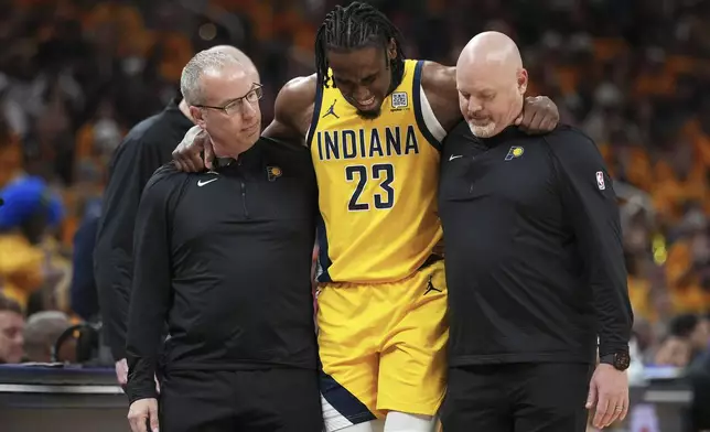 Indiana Pacers forward Aaron Nesmith (23) is assisted off the court during the second half of Game 3 of the Eastern Conference finals of the NBA basketball playoffs against the New York Knicks Sunday, May 25, 2025, in Indianapolis. (AP Photo/AJ Mast)