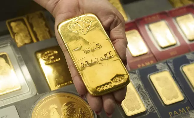 Sam Nguyen shows a gold bar at her shop in the St. Vincent Jewelry Center in the Jewelry District of Los Angeles, Wednesday, April 30, 2025. (AP Photo/Jae C. Hong)