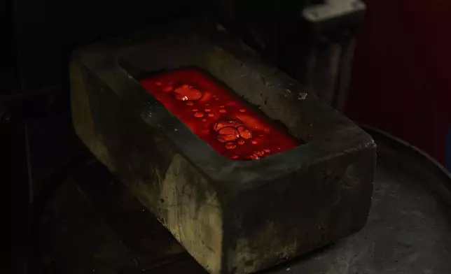 Molten gold settles in a mold at A&amp;M Precious Metals in the St. Vincent Jewelry Center in the Jewelry District of Los Angeles, Friday, May 2, 2025. (AP Photo/Jae C. Hong)