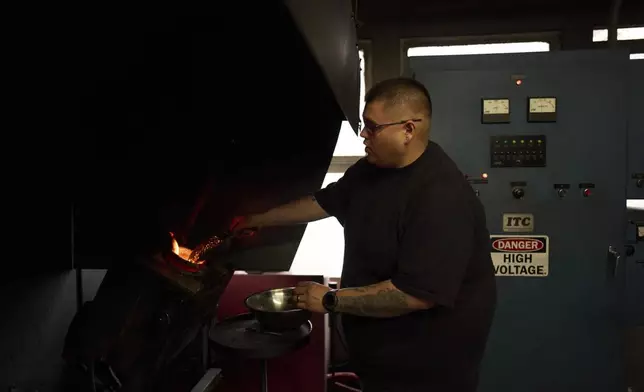 Melter Alberto Hernandez loads gold into a crucible at A&amp;M Precious Metals in the St. Vincent Jewelry Center in the Jewelry District of Los Angeles, Friday, May 2, 2025. (AP Photo/Jae C. Hong)