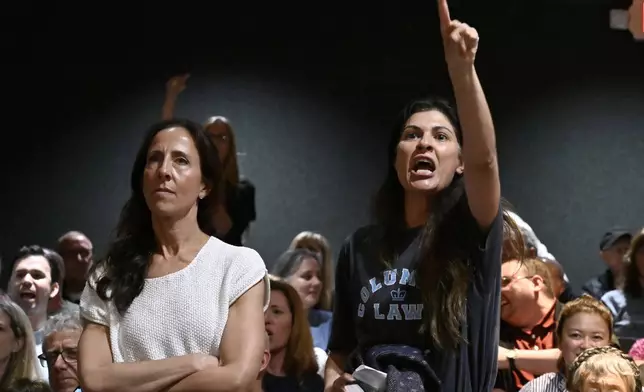Audience members react to U.S. Rep. Mike Lawler, R-N.Y., speaking at a town hall, Sunday, May 4, 2025, in Somers, N.Y. (AP Photo/Jessica Hill)