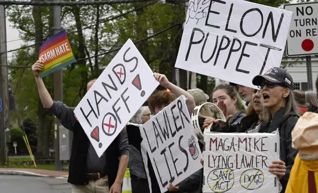 Protesters call out to vehicles driving through town before a town hall held by U.S. Rep. Mike Lawler, R-N.Y.Sunday, May 4, 2025, in Somers, N.Y. (AP Photo/Jessica Hill)