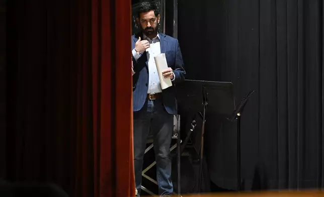 U.S. Rep. Mike Lawler, R-N.Y., makes the sign of the cross after the invocation prayer before his town hall, Sunday, May 4, 2025, in Somers, N.Y. (AP Photo/Jessica Hill)