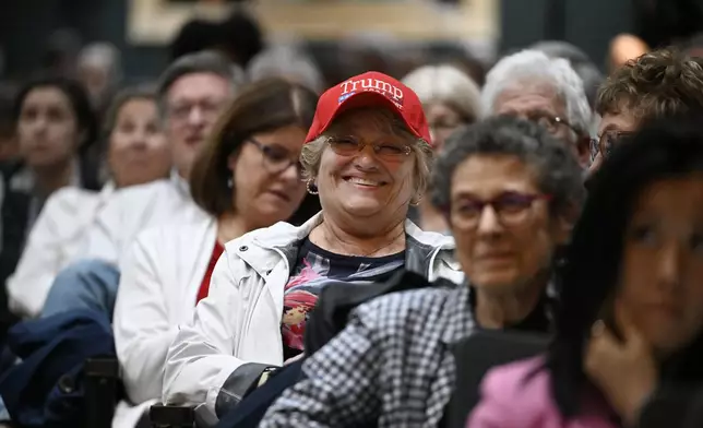 An audience member smiles while listening to a town hall held by U.S. Rep. Mike Lawler, R-N.Y., Sunday, May 4, 2025, in Somers, N.Y. (AP Photo/Jessica Hill)