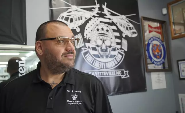 Ralph Rodriguez poses for a portrait at his pawn and gun shop in Fayetteville, N.C., Friday, May 9, 2025. (AP Photo/Allen G. Breed)