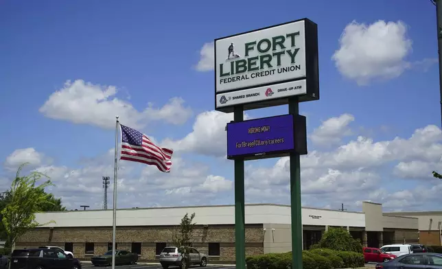 An American flag flaps in the breeze outside the Fort Liberty Federal Credit Union on Friday, May 9, 2025. The business changed its name after Fort Bragg was rechristened, and is now having to change it back. (AP Photo/Allen G. Breed)
