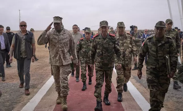 Gen. Michael Langley, USMC, Commander, U.S. Africa Command, center, and Major General Mohammed Berrid, Inspector General of Moroccan Royal Armed Forces, attend the 21st edition of the African Lion military exercise, in Tantan, south of Agadir, Morocco, Friday, May 23, 2025. (AP Photo/Mosa'ab Elshamy)