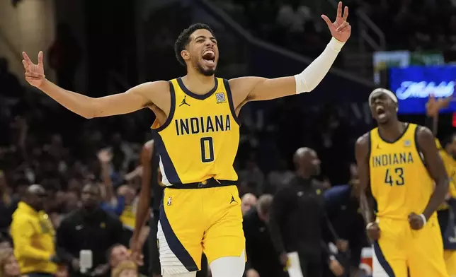 Indiana Pacers guard Tyrese Haliburton, left, celebrates along with forward Pascal Siakam after scoring during the second half in Game 5 of an Eastern Conference semifinal NBA basketball playoff against the Cleveland Cavaliers, Tuesday, May 13, 2025, in Cleveland. (AP Photo/Sue Ogrocki)