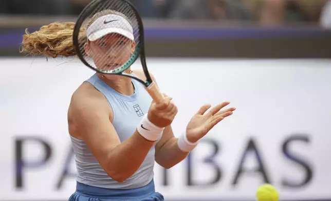 Mirra Andreeva returns the ball to United States' Coco Gauff during their tennis match at the Italian Open at the Foro Italico, in Rome, Wednesday, May 14, 2025.(AP Photo/Alessandra Tarantino)