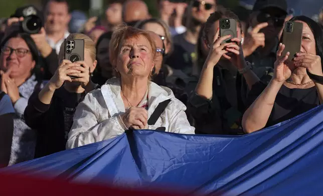People attend an electoral rally supporting Presidential candidate Nicusor Dan a week ahead of the second round of the country's presidential election redo in Bucharest, Romania, Sunday, May 11, 2025. (AP Photo/Andreea Alexandru)