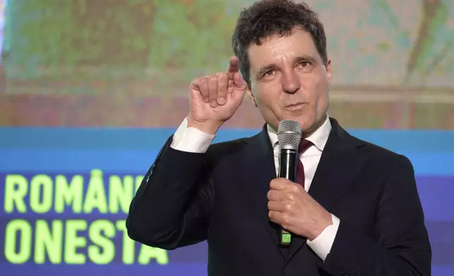 Presidential candidate Nicusor Dan gestures during an electoral rally, a week ahead of the second round of the country's presidential election redo in Bucharest, Romania, Sunday, May 11, 2025. (AP Photo/Vadim Ghirda)