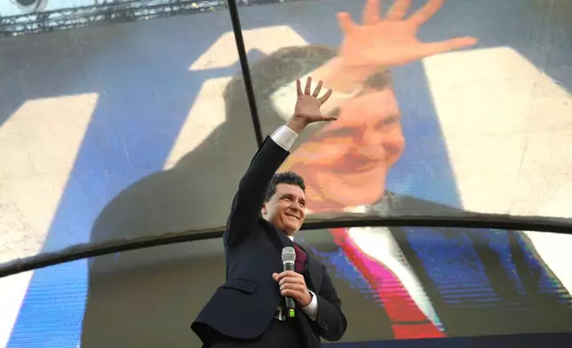 Presidential candidate Nicusor Dan waves during an electoral rally a week ahead of the second round of the country's presidential election redo in Bucharest, Romania, Sunday, May 11, 2025. (AP Photo/Vadim Ghirda)