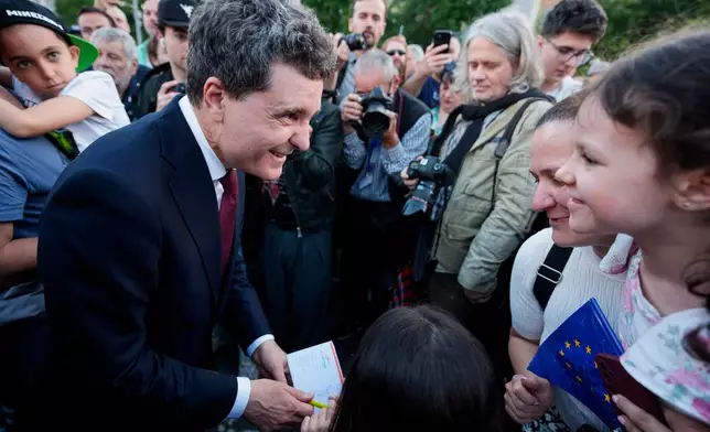Presidential candidate Nicusor Dan, left, speaks to supporters during an electoral rally a week ahead of the second round of the country's presidential election redo in Bucharest, Romania, Sunday, May 11, 2025. (AP Photo/Andreea Alexandru)