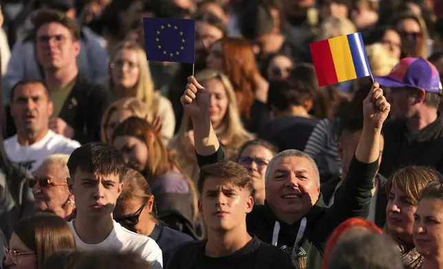 People attend an electoral rally supporting Presidential candidate Nicusor Dan a week ahead of the second round of the country's presidential election redo in Bucharest, Romania, Sunday, May 11, 2025. (AP Photo/Andreea Alexandru)