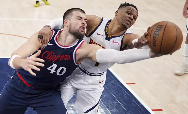Los Angeles Clippers center Ivica Zubac, left, and Denver Nuggets guard Russell Westbrook reach for a rebound during the second half in Game 6 of an NBA basketball first-round playoff series Thursday, May 1, 2025, in Inglewood, Calif. (AP Photo/Mark J. Terrill)