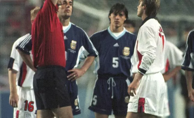 FILE - Denmark's refferee Kim Milton Nielsen gives England's David Beckham a red card during the England vs Argentina second round World Cup 98, soccer match at Geoffroy Guichard Stadium in Saint Etienne, on June 30, 1998. (AP Photo/Denis Doyle, File)