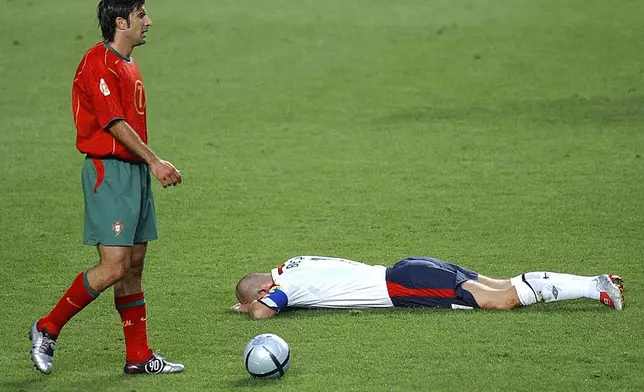 FILE - Portugal's Luis Figo, left, walks by England's David Beckham during their Euro 2004 quarterfinal soccer match at the Luz Stadium in Lisbon, Portugal, June 24, 2004. (AP Photo/Armando Franca, File)